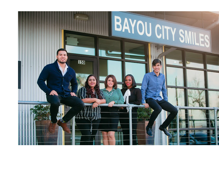 A group of people in a bayside city, smiling and working together as a team