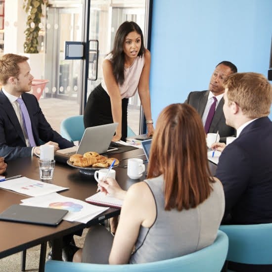 A group of business professionals discussing in a meeting room, exchanging ideas and collaborating on projects.