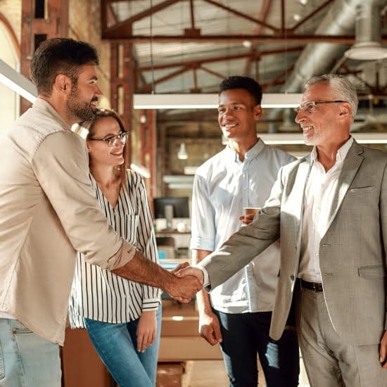 Business people shaking hands in an office.