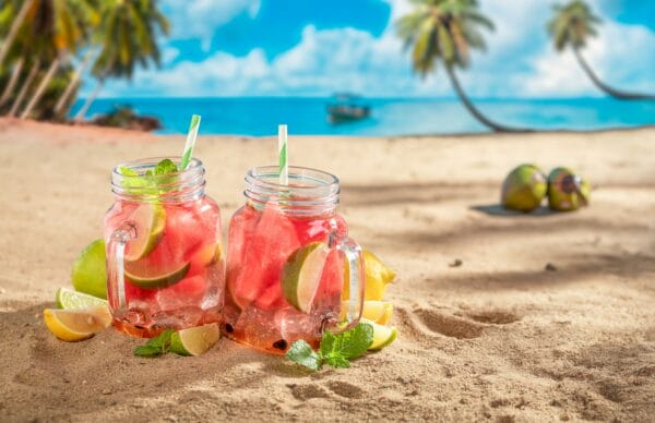 Lemonade with watermelon on beach at ocean in summer.